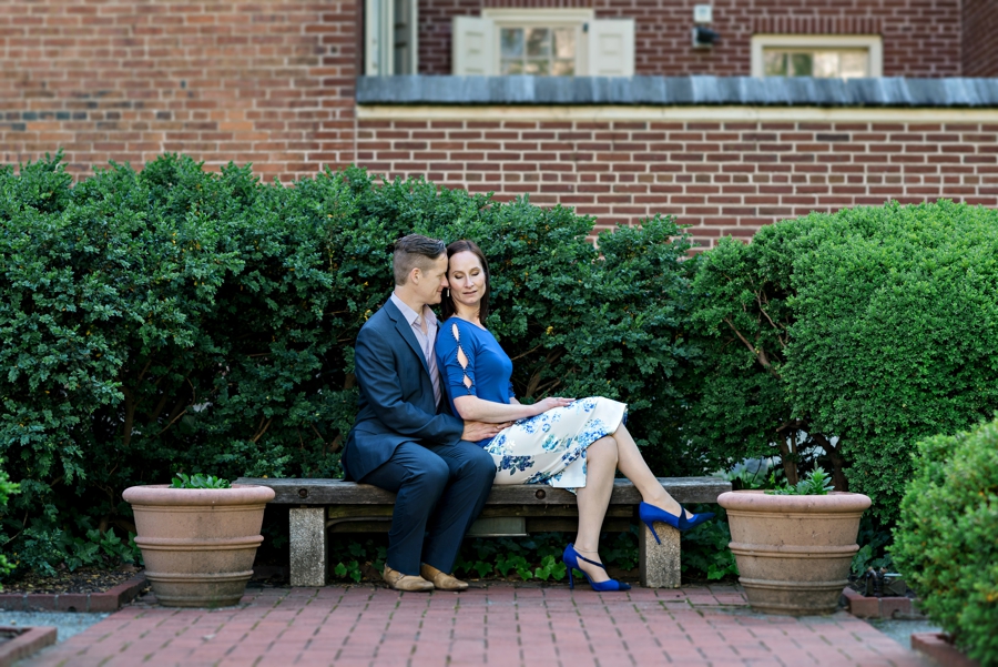 A loving couple sit in a city square in philadelphia.